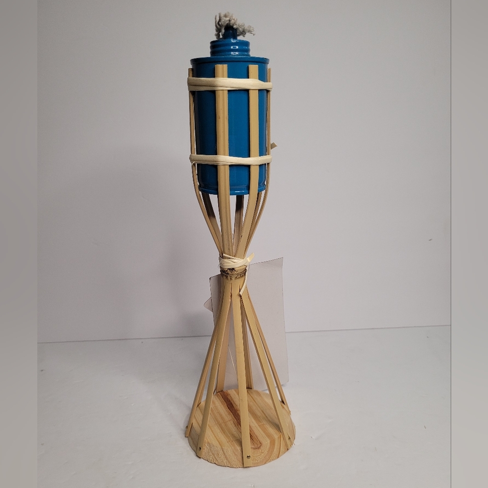 This is a tiki torch with a blue metallic canister for fuel. The canister is hel